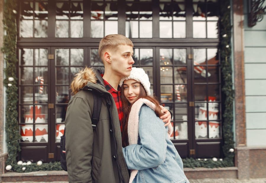 A couple embracing warmly on a winter street