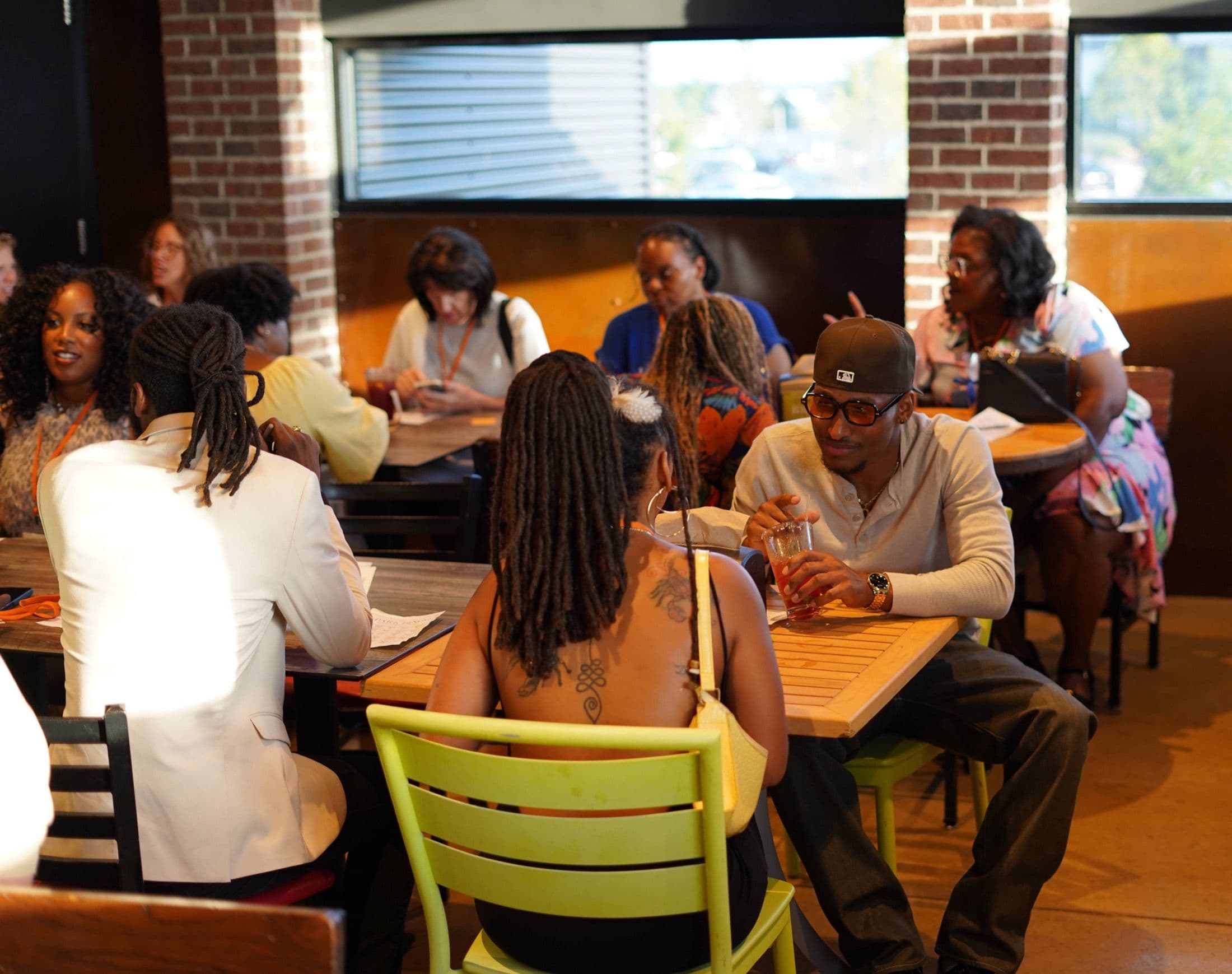 Guests talking at tables during a Beyond The Sparks compatibility dating event.