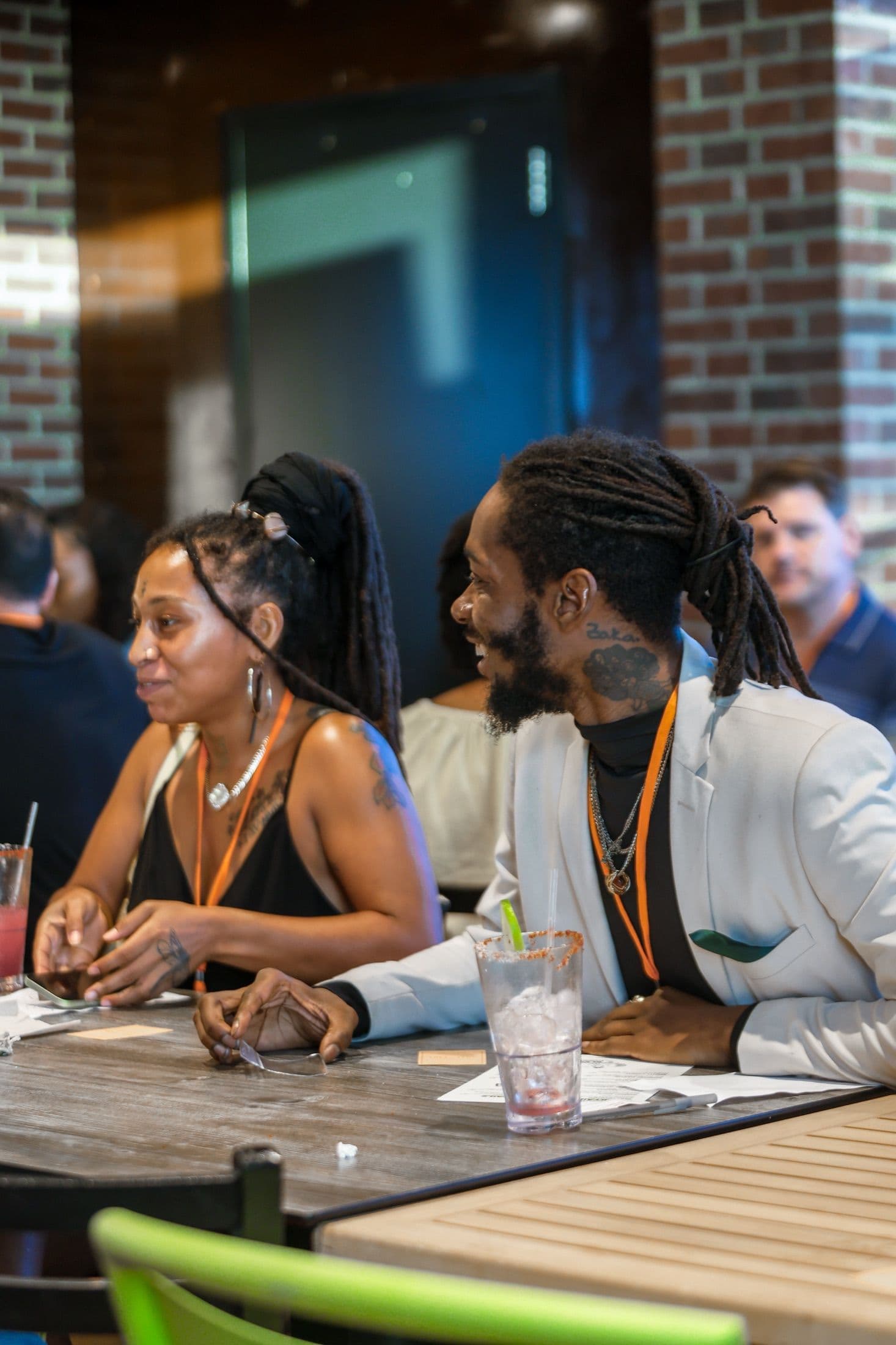 A couple sitting together and smiling at a Beyond The Sparks singles event.