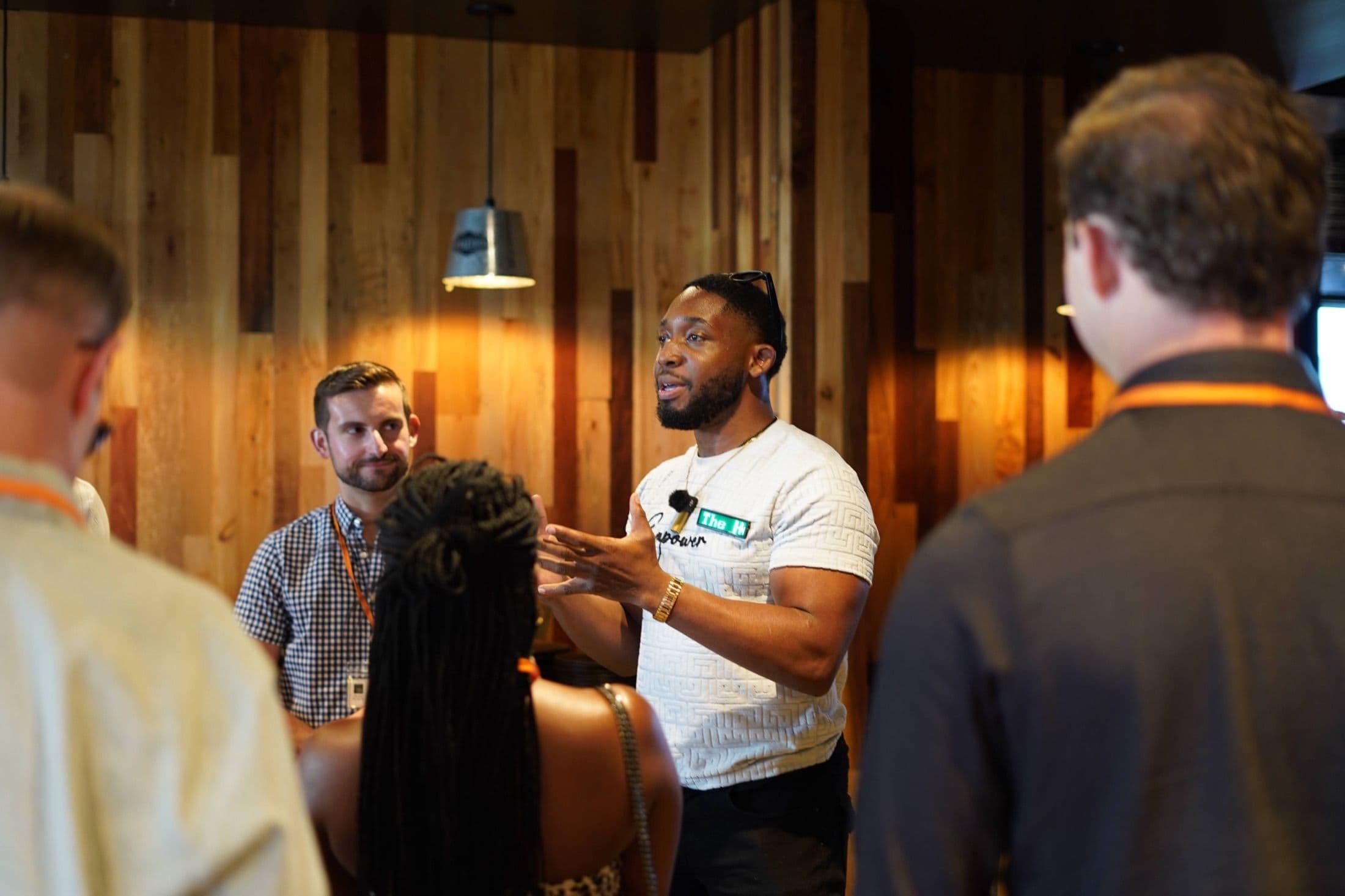 A Beyond The Sparks host explaining the format to a small group of guests.