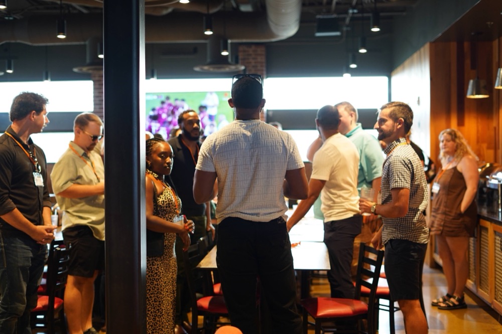 Guests mingling in small groups at a Beyond The Sparks singles event.